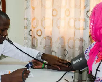 Health service provider with a client in Zimbabwe